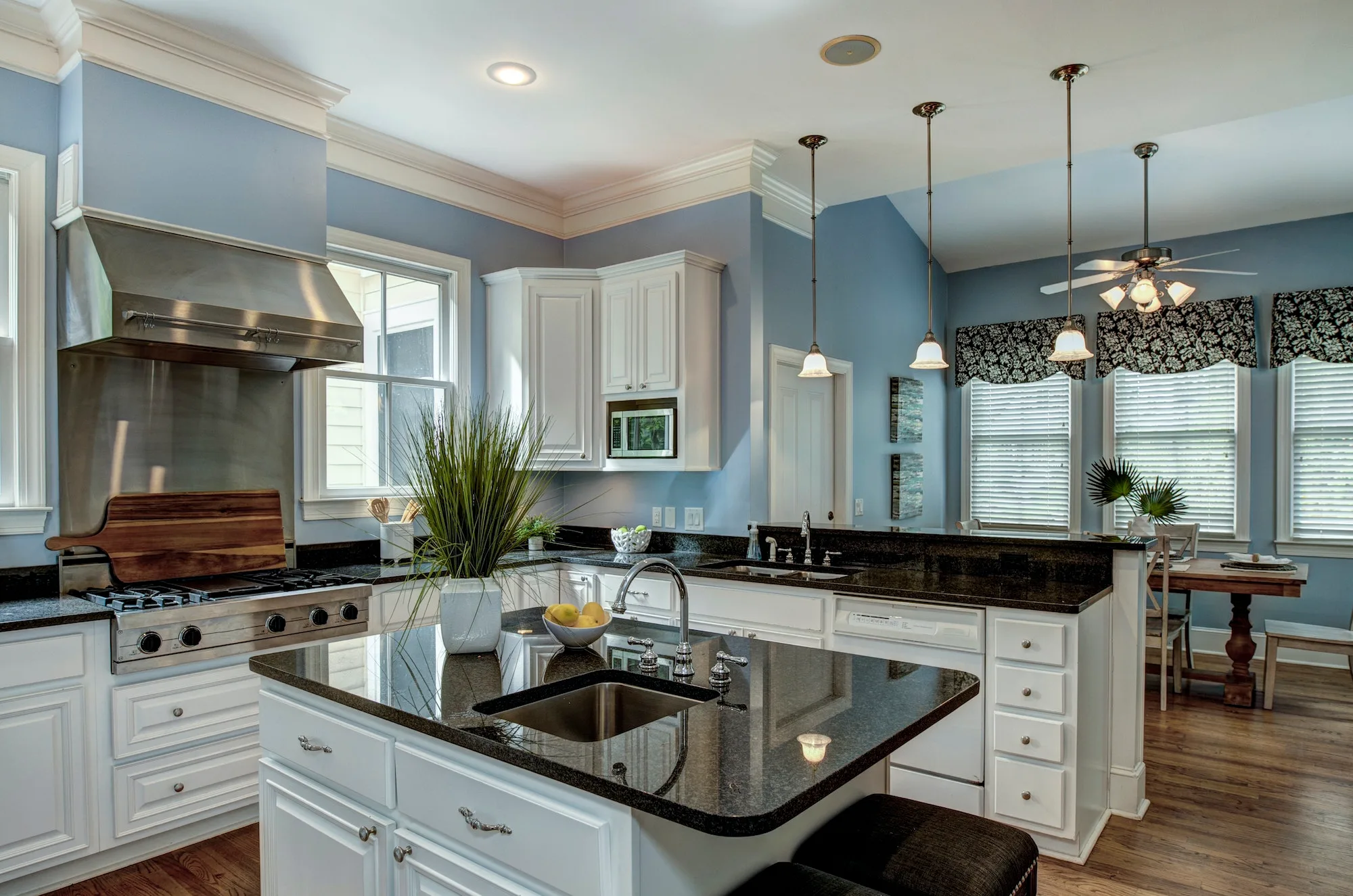 Large American style kitchen and dining room interior with granite countertops